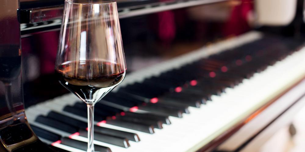 Wine glass sitting on piano